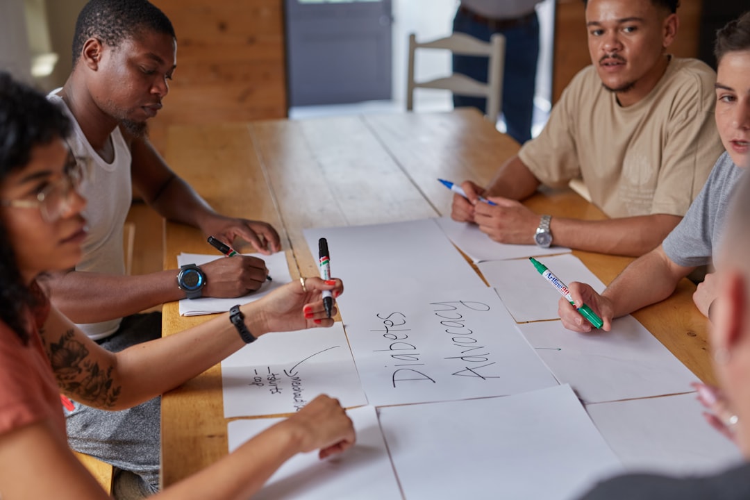 data privacy — a group of people sitting around a wooden table